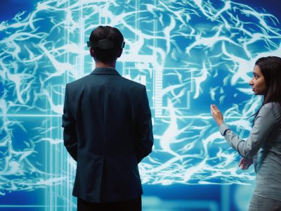 Engineers use VR headset and AR hologram, looking at AI neural networks modeled after human brain. Admins using artificial intelligence, virtual and augmented reality tech to look at data, camera B